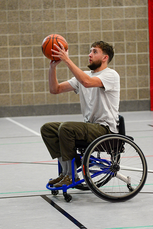 Male playing adaptive wheelchair basketball